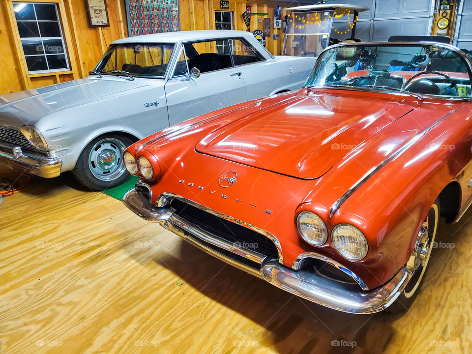 A 1964 Chevy Nova and a 1962 Chevy Corvette occupy the same garage in a display of classic American automobile history