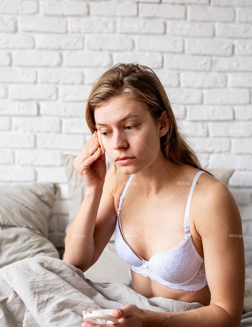 woman using cosmetics at home