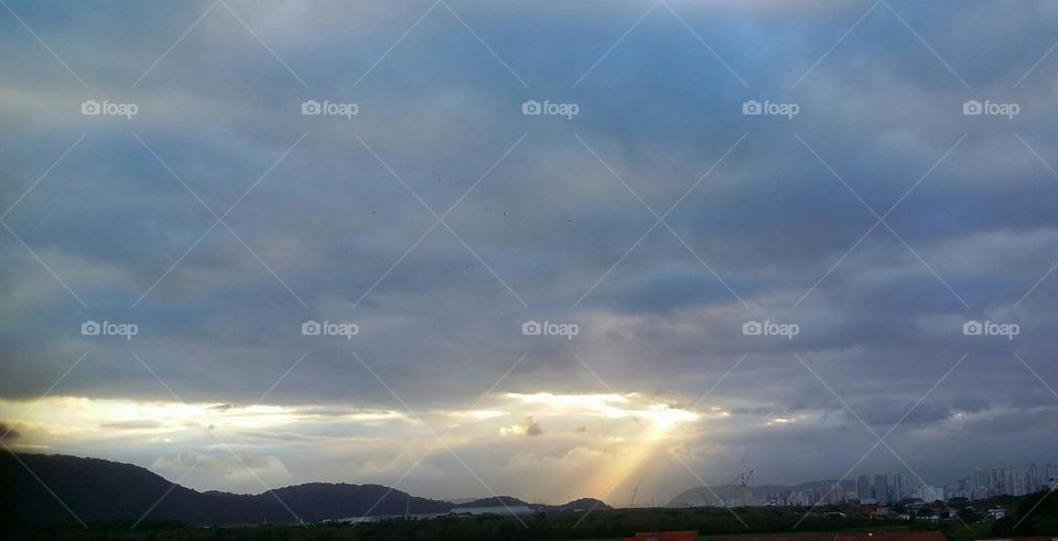 Sun ray between clouds