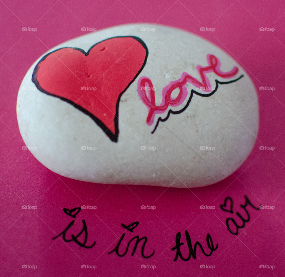 Love is in the air hand painted rock