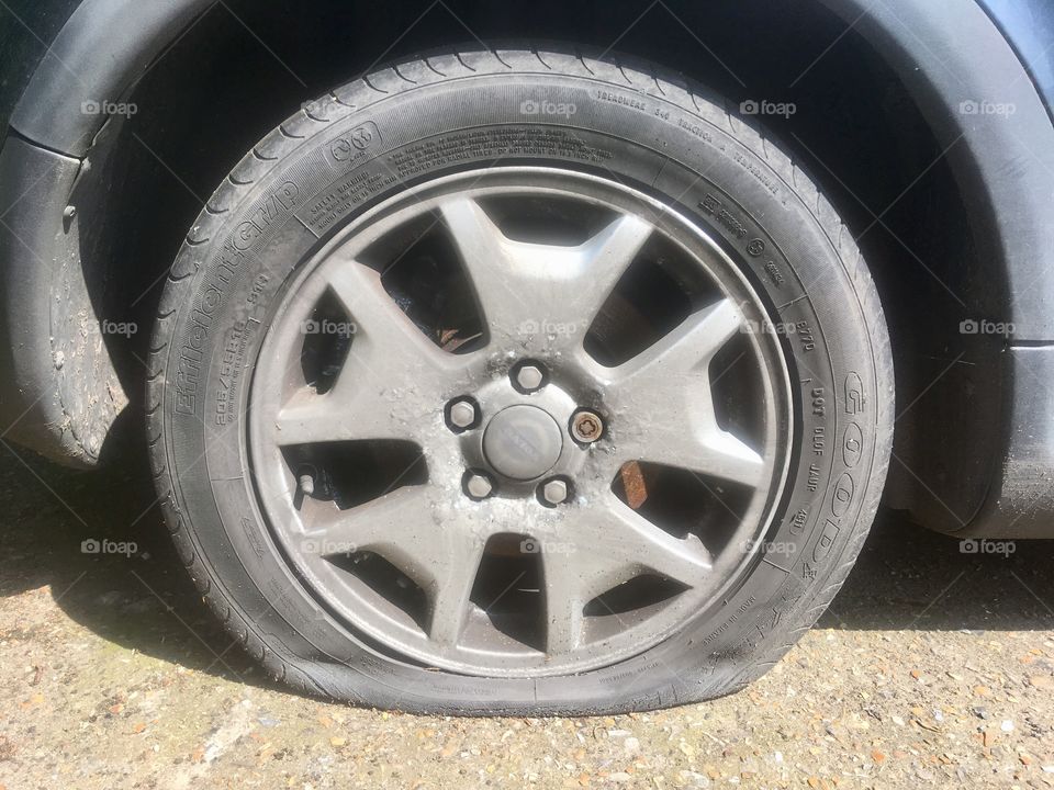 Flat Goodyear EfficientGrip 205/55R16 tyre on a van in a car park in North Watford, Hertfordshire
