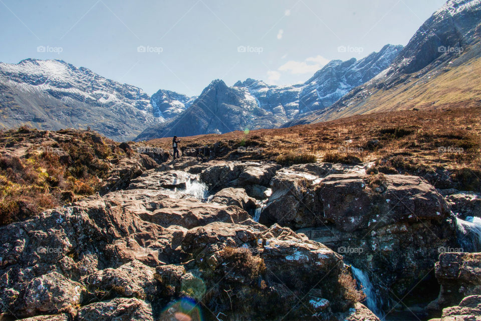 Man taking a photo of the fairy pools 