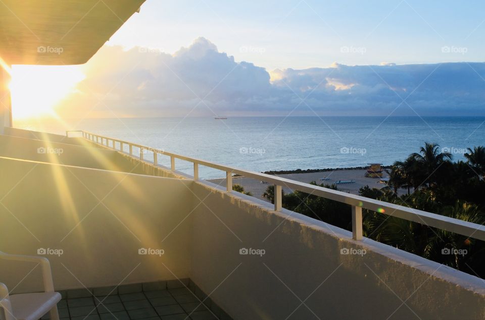 Gorgeous golden bright yellow sun is setting off in the distant horizon seen from balcony!!