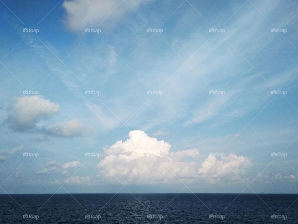 Cloudscape on the sea, the beauty of cumulus clouds "crowned" cirrostratus.