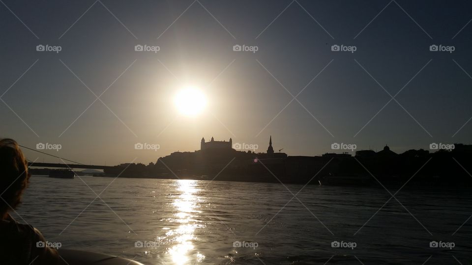 Bratislava castle between sun and river Danube