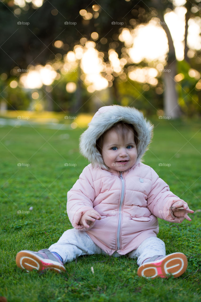 baby girl wearing pink coat with a fur hood