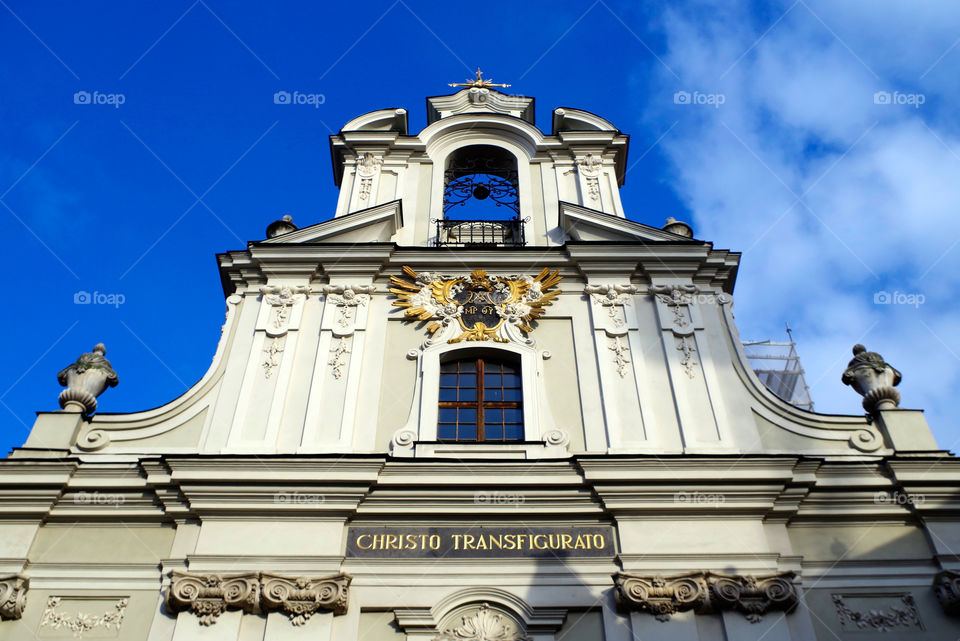 Low angle view of building exterior against clear blue sky in Cracow, Poland.