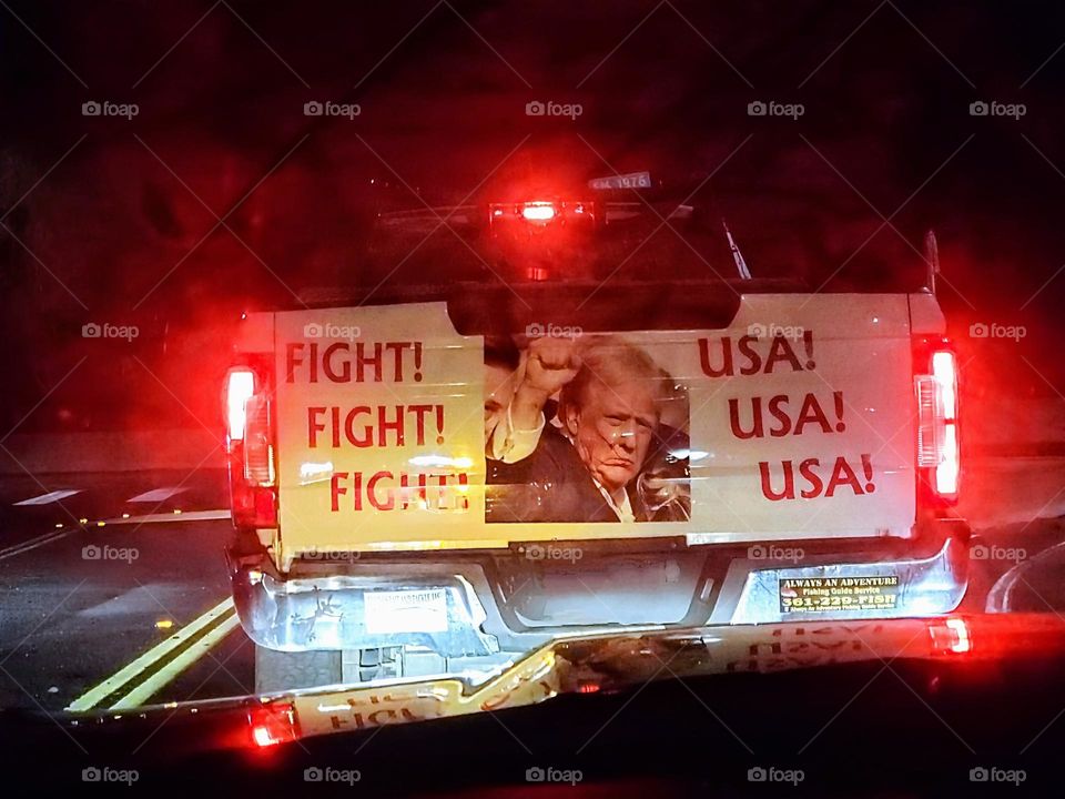 A truck tailgate showing an image of and words of the assassination attempt of the USA President Donald Trump.