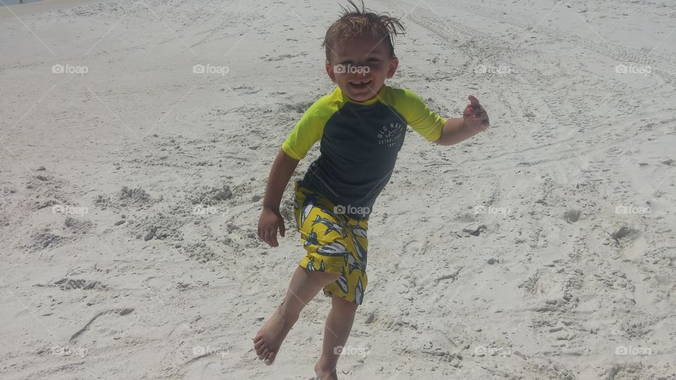 young nephew having fun on beach