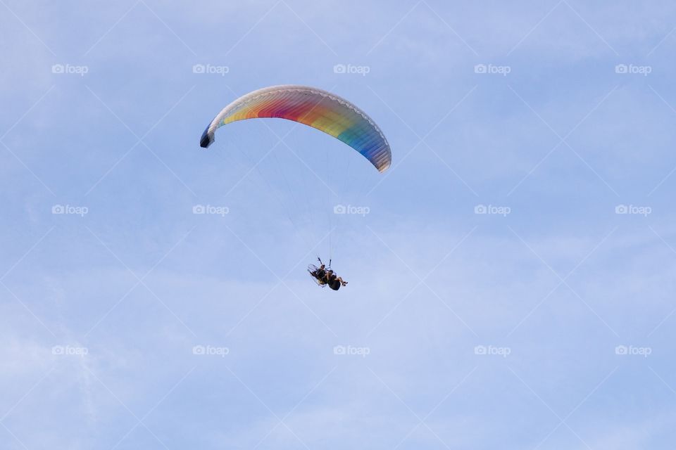 Paraglider flying a parachute.