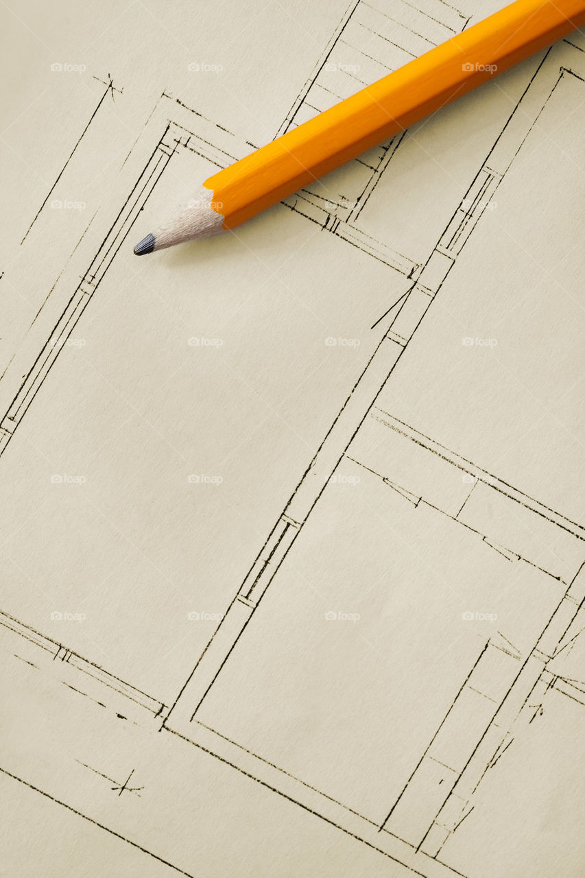 Pencil on a paper with a house blueprint on it