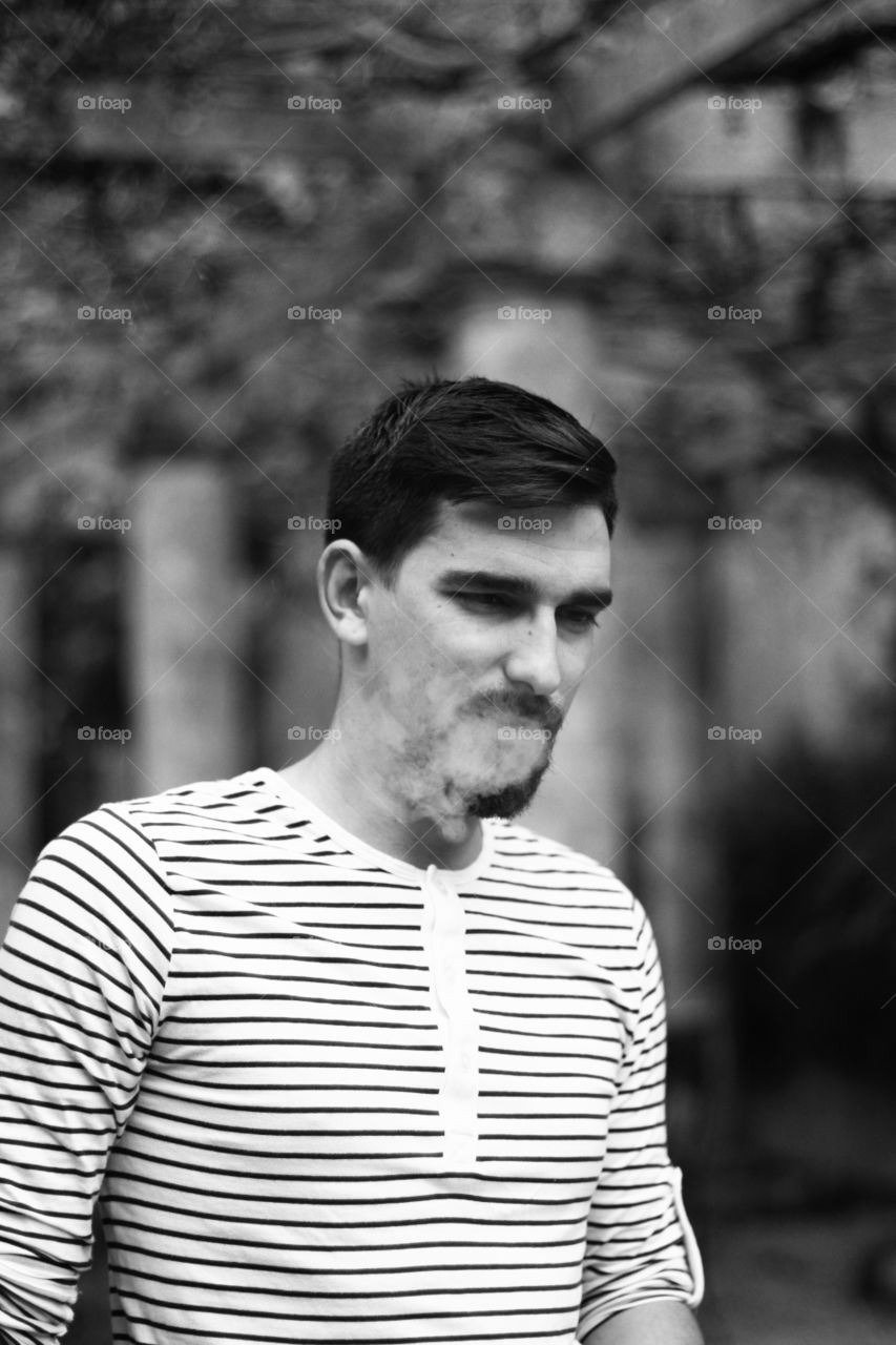 a man smoking his cigarette