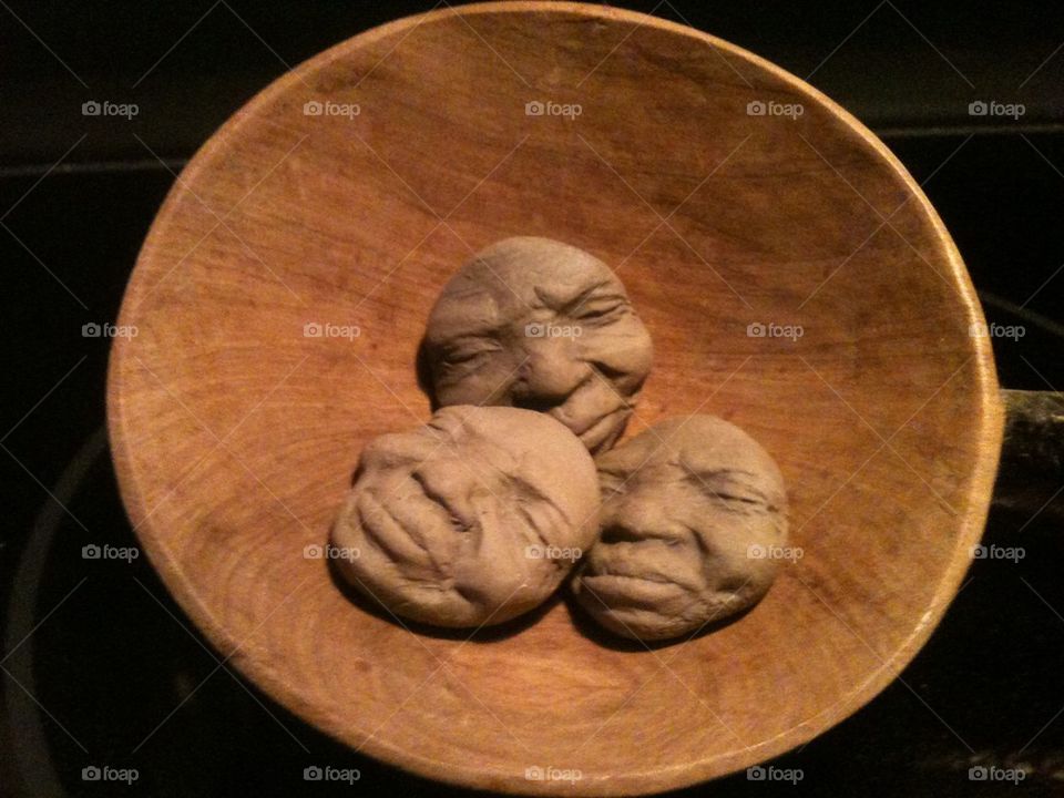 Heads in a wooden bowl