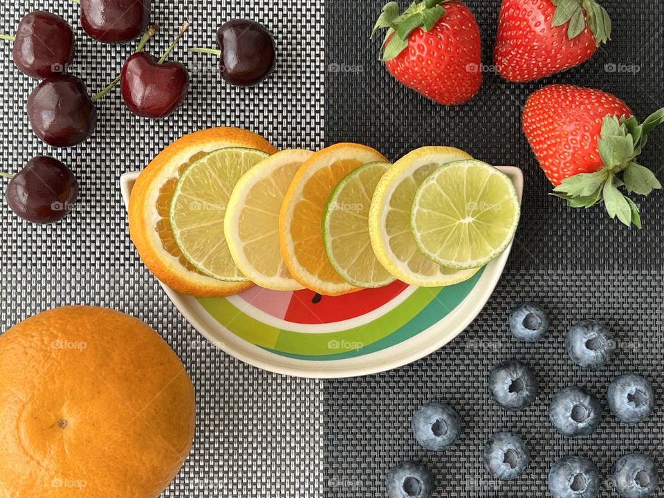 Colourful Flatly with blueberries, strawberries,cherries, oranges and lemons. 