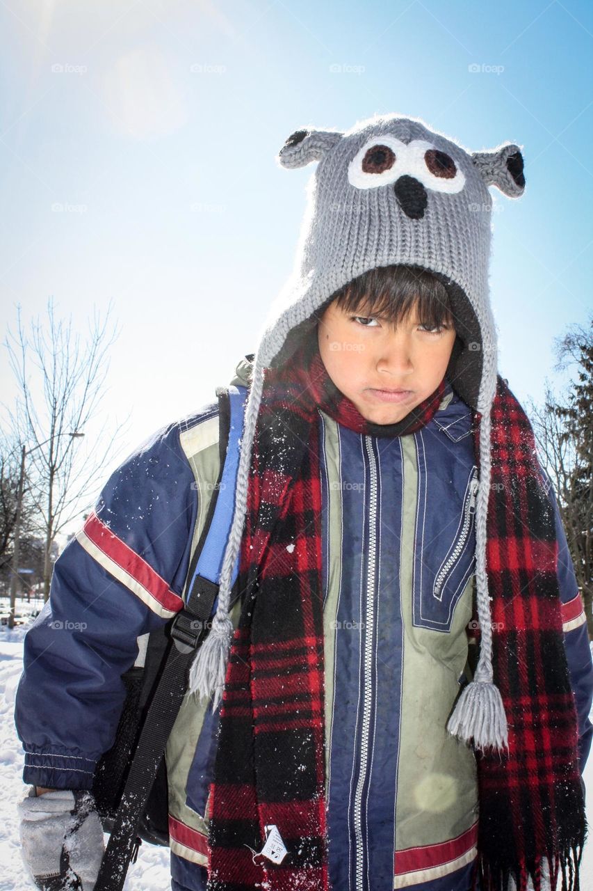 Cute little boy in a crazy outfit in winter