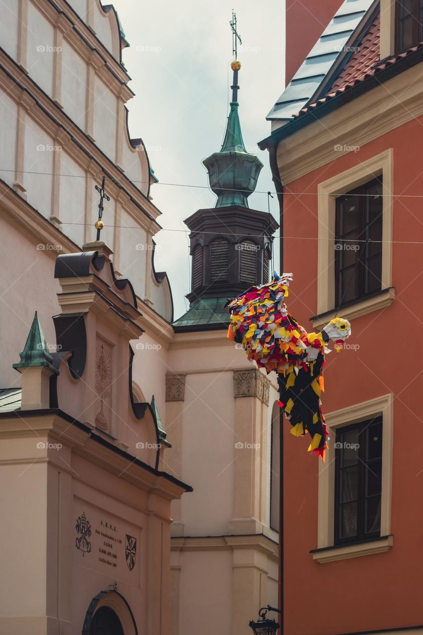 decorations hanging on the streets of the old town of Lublin in the background the historic Dominican church