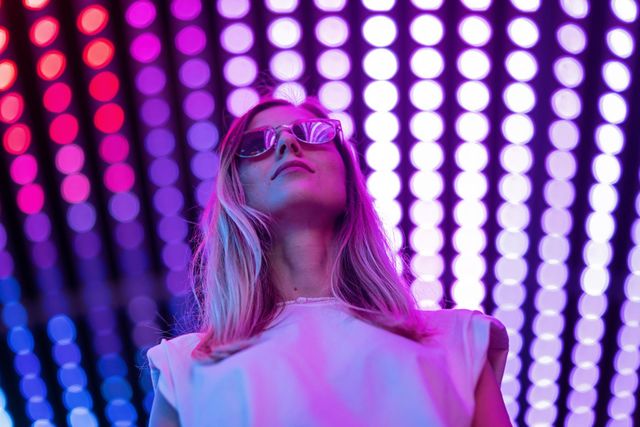 Stylish Caucasian woman in light tunnel 