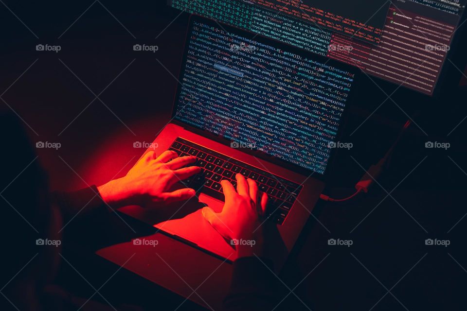 Man using computer and programming  to break code. Cyber security threat. Internet and network security. Stealing private information. Person using technology to steal password and private data. Cyber attack crime