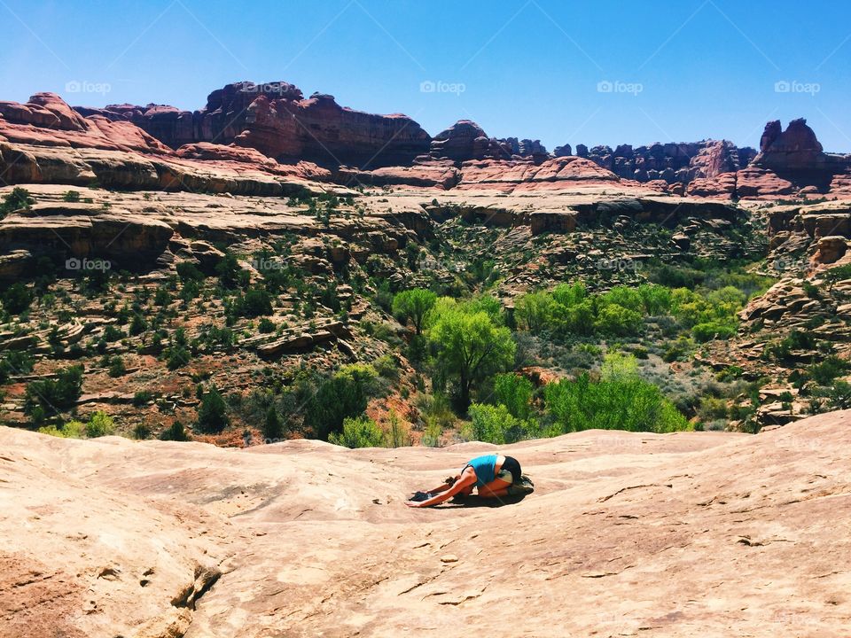 Woman practicing yoga on mountain