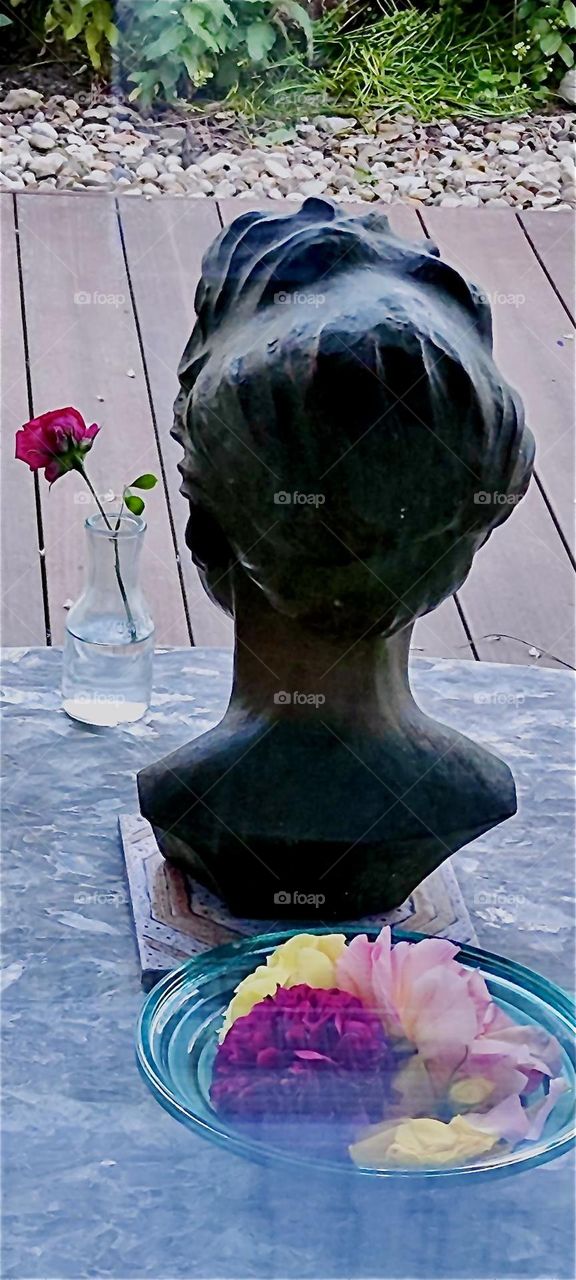 This classic art bust was made in the likeness of a beautiful woman who passed away decades ago and is missed by her loved ones. Today she is facing towards the garden outside. 2024. Hypnotic Productions