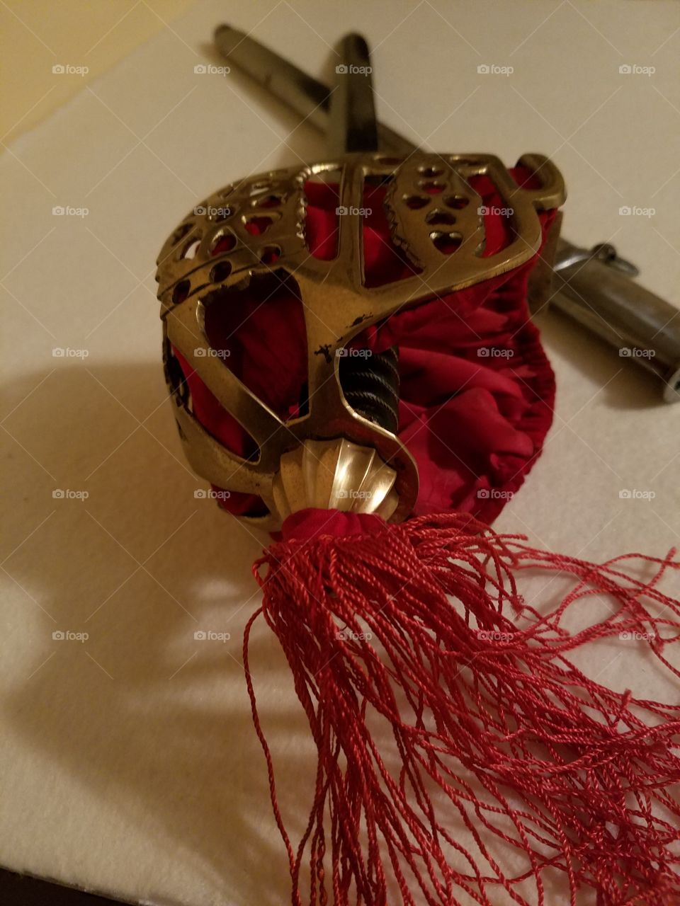 antique sword red velvet lining covering the inside of the hand guard with red tassel