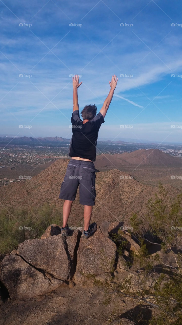 Taking a Leap of Faith. symbolic leap of faith after hiking to the top of sunrise trail Scottsdale Arizona McDowell mountains