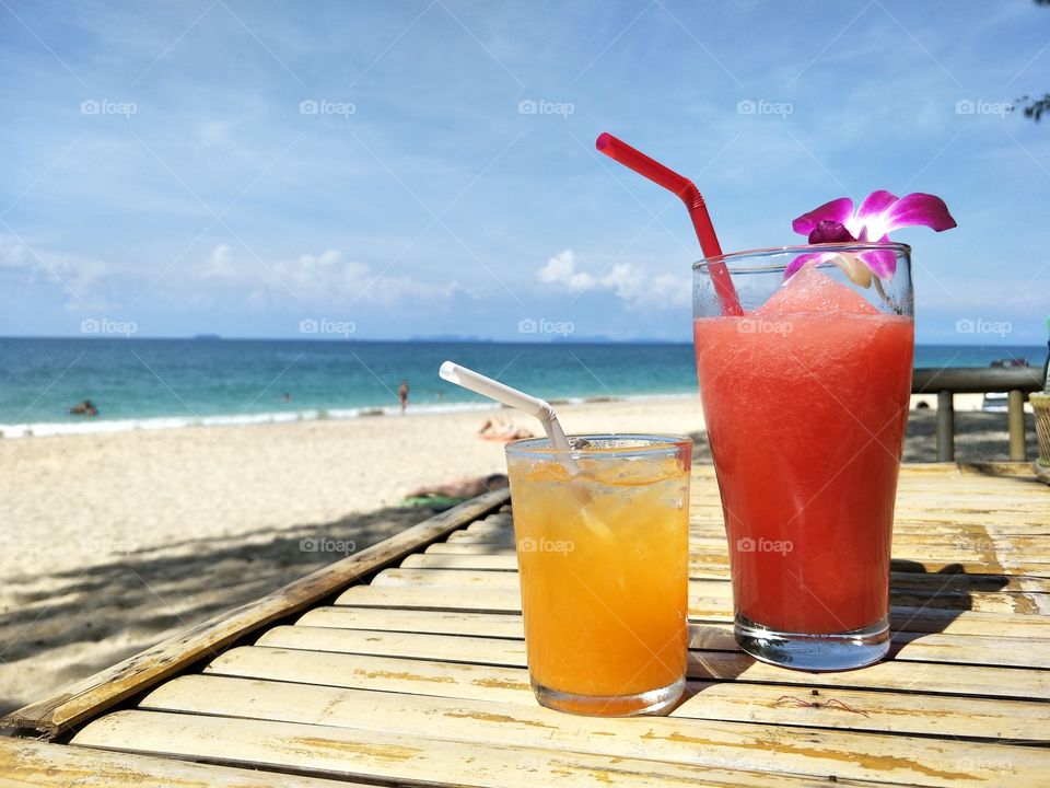 watermelon and orange juice on the beach relax yummy happy time in summer at koh lanta, thailand