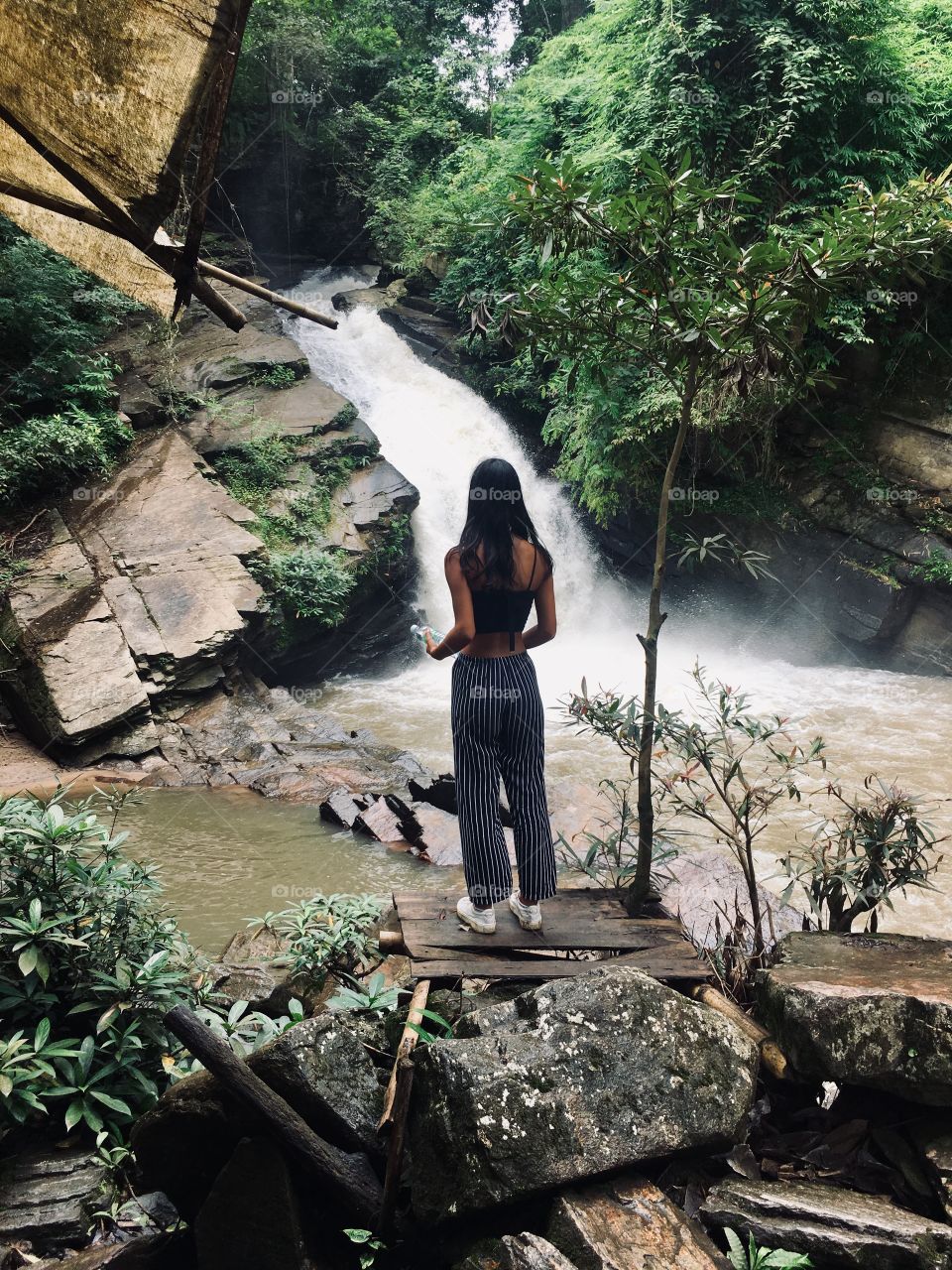 Girl Mesmerizing Nature’s Waterfall  