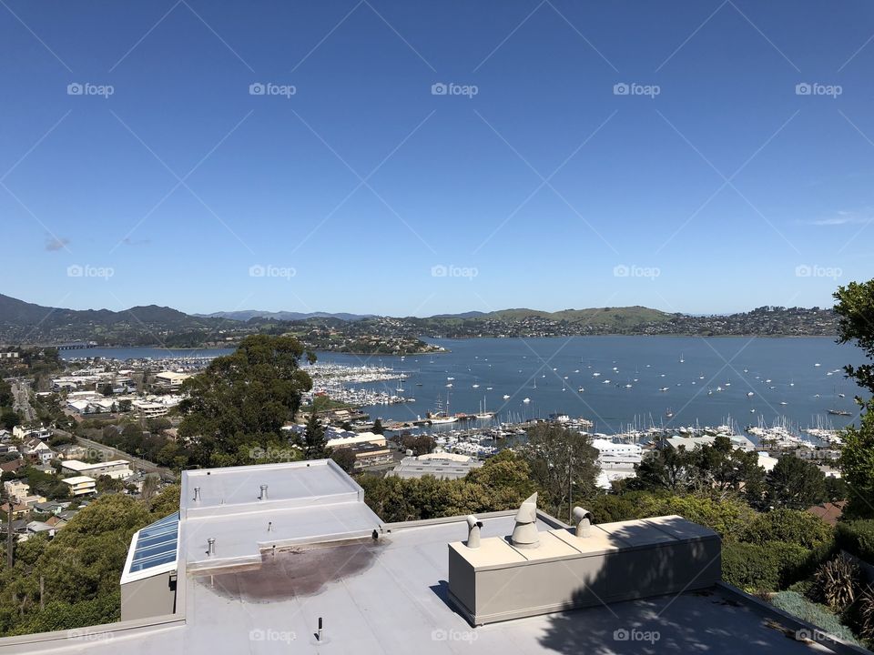View of Bay Area in California from rooftop showing boats and mountains in background