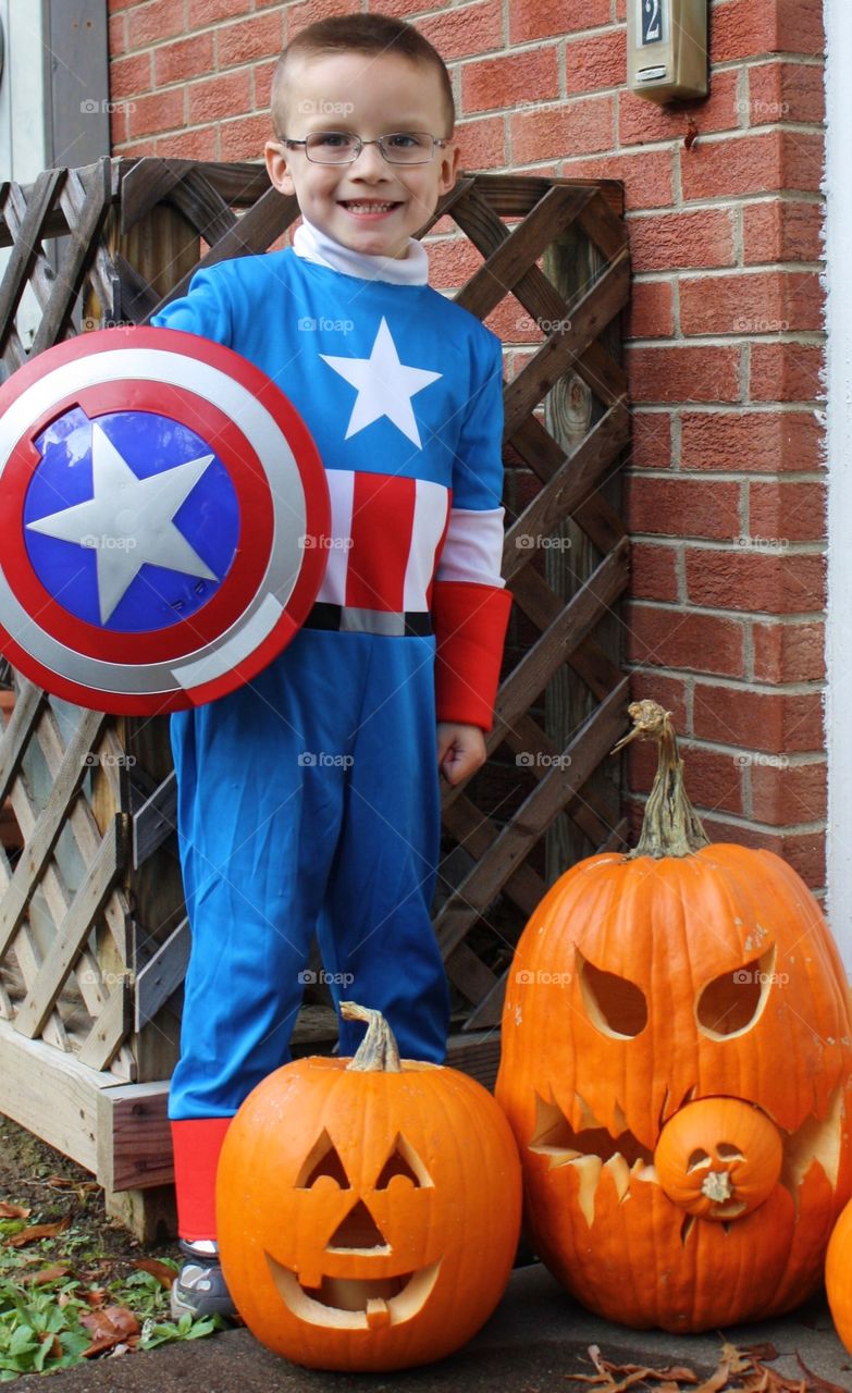 Boy wearing superhero costume on halloween
