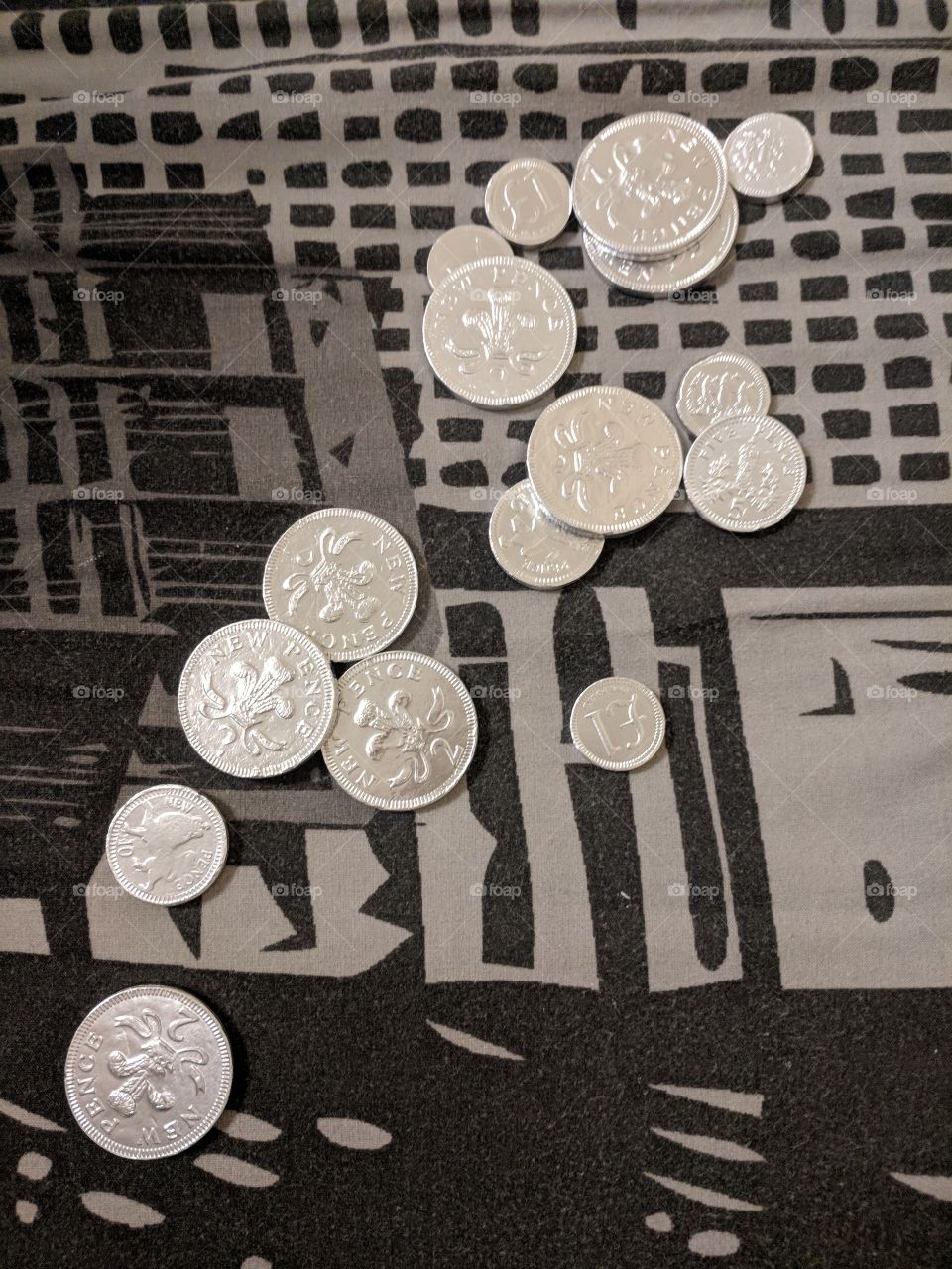 UK Silver Chocolate Coins on a Monochrome Background