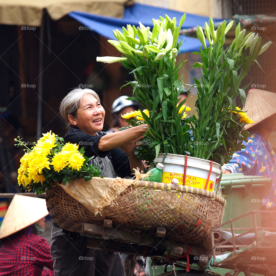 Vietnamese woman selling flowers