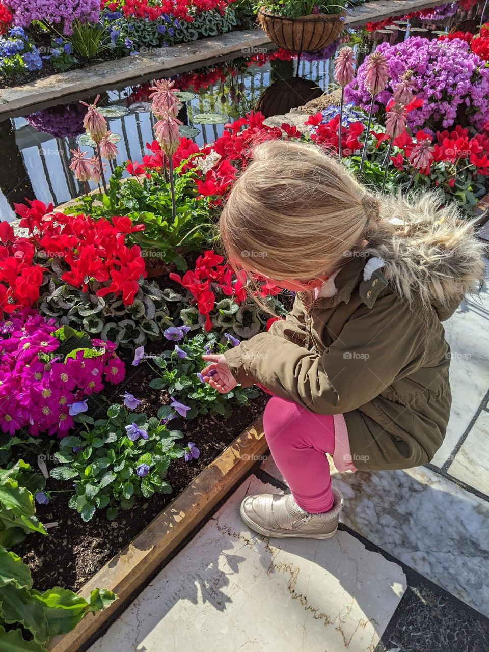 curious girl with beautiful flowers