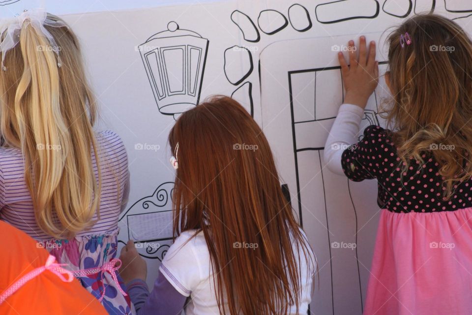 kids coloring a wall