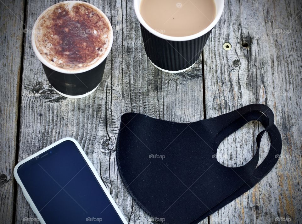 Mask with phone and coffee cups 