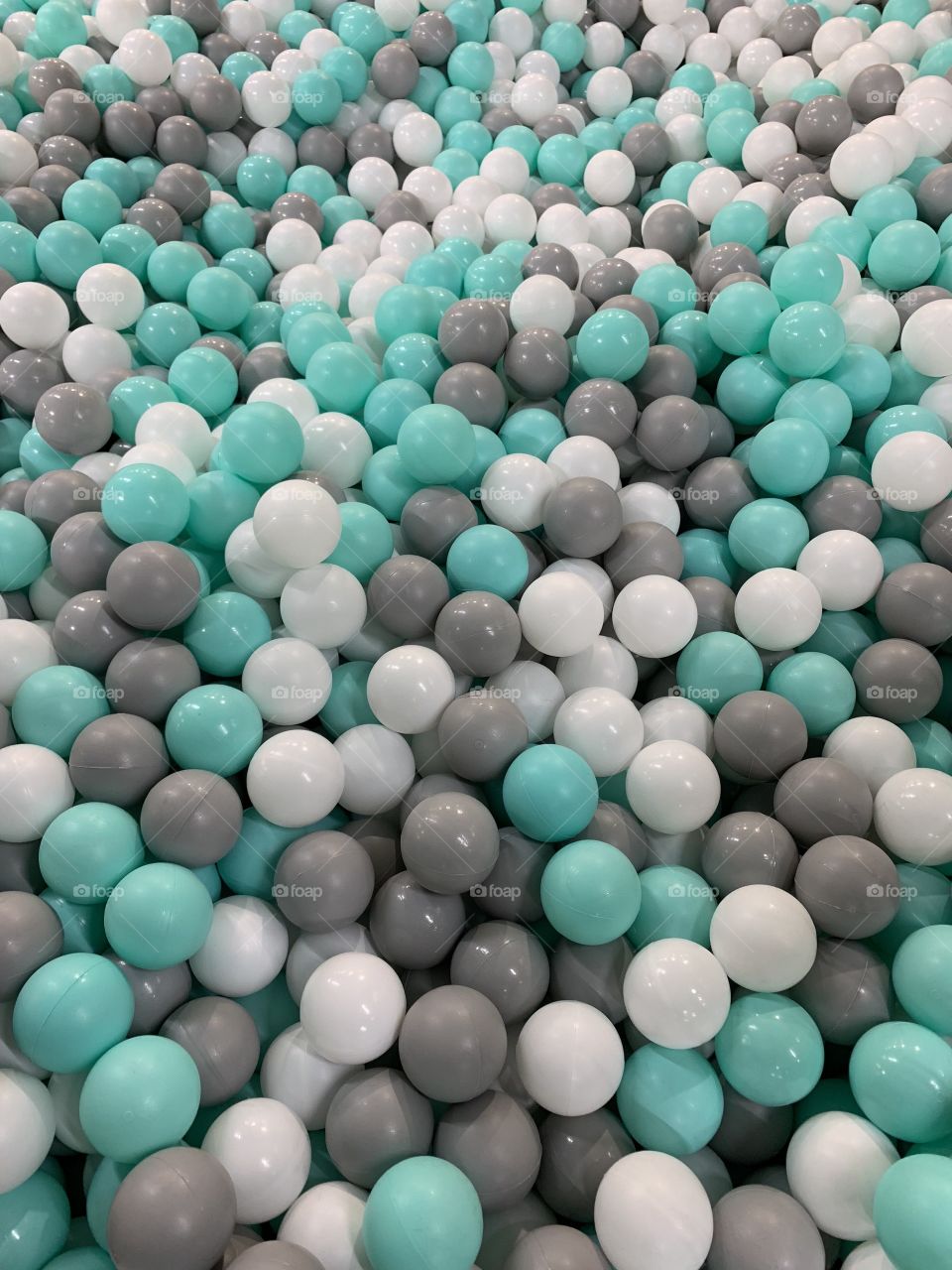 multicolored plastic balls in a dry pool for children