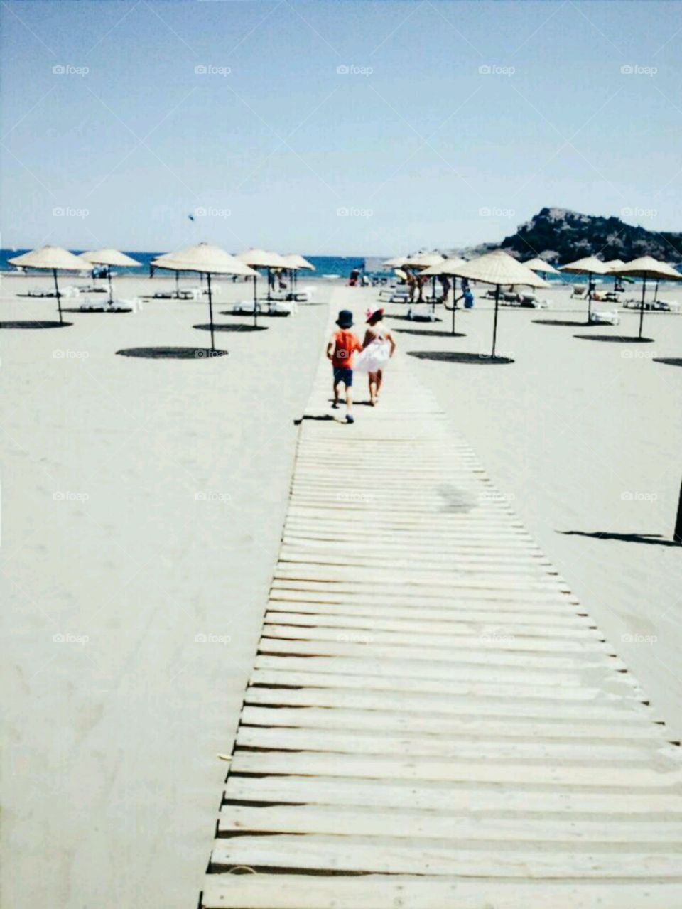 Kids walking on boardwalk at beach