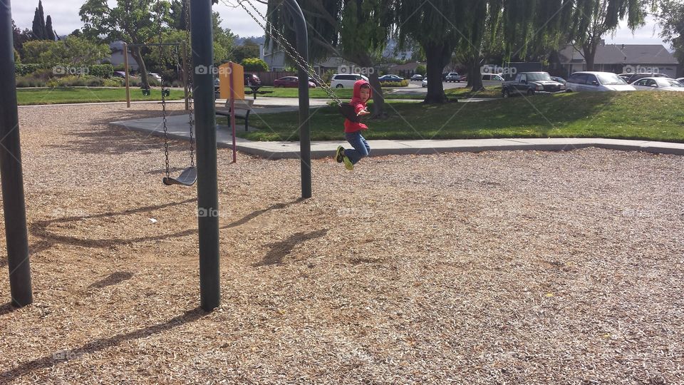 Boy playing on swing
