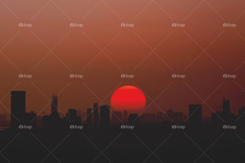 Sunset over silhouette of skyscraper