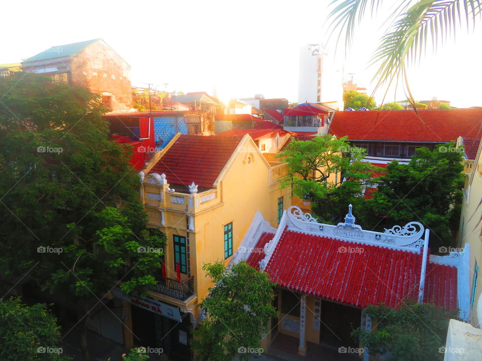 Vivid red tile rooftop of the buildings in The Old Quarter of Hanoi Vietnam 
From our balcony 