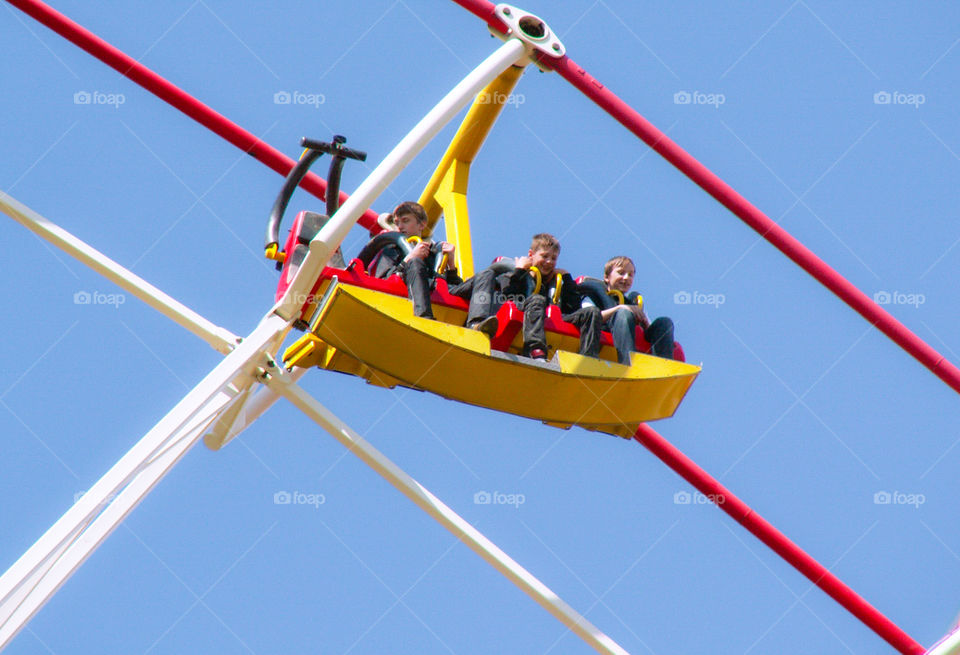 The girl is riding on a swing