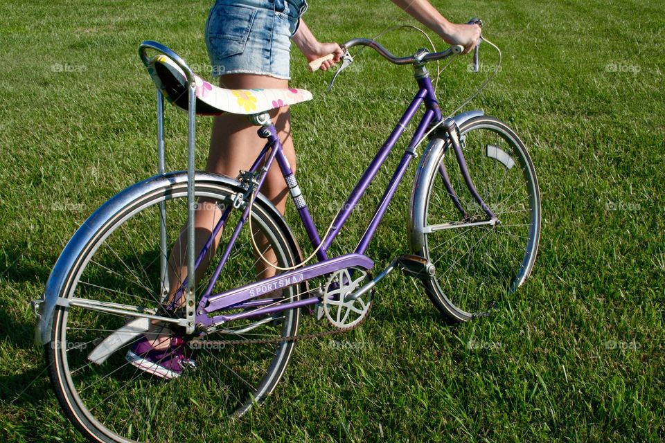 Girl with retro bicycle with flower banana seat