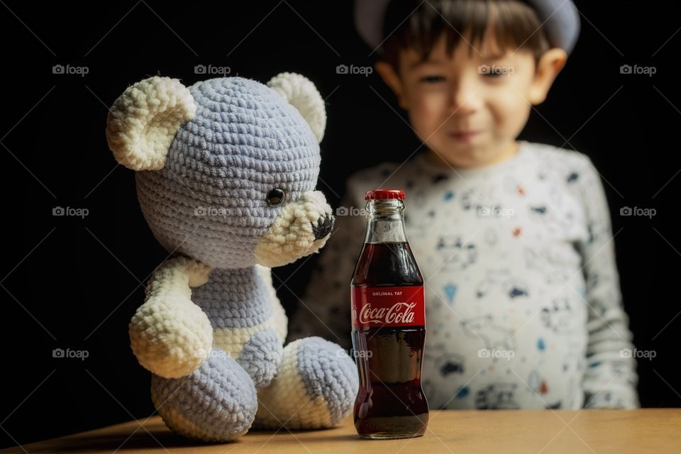 Boy, teddy bear, and Coca cola