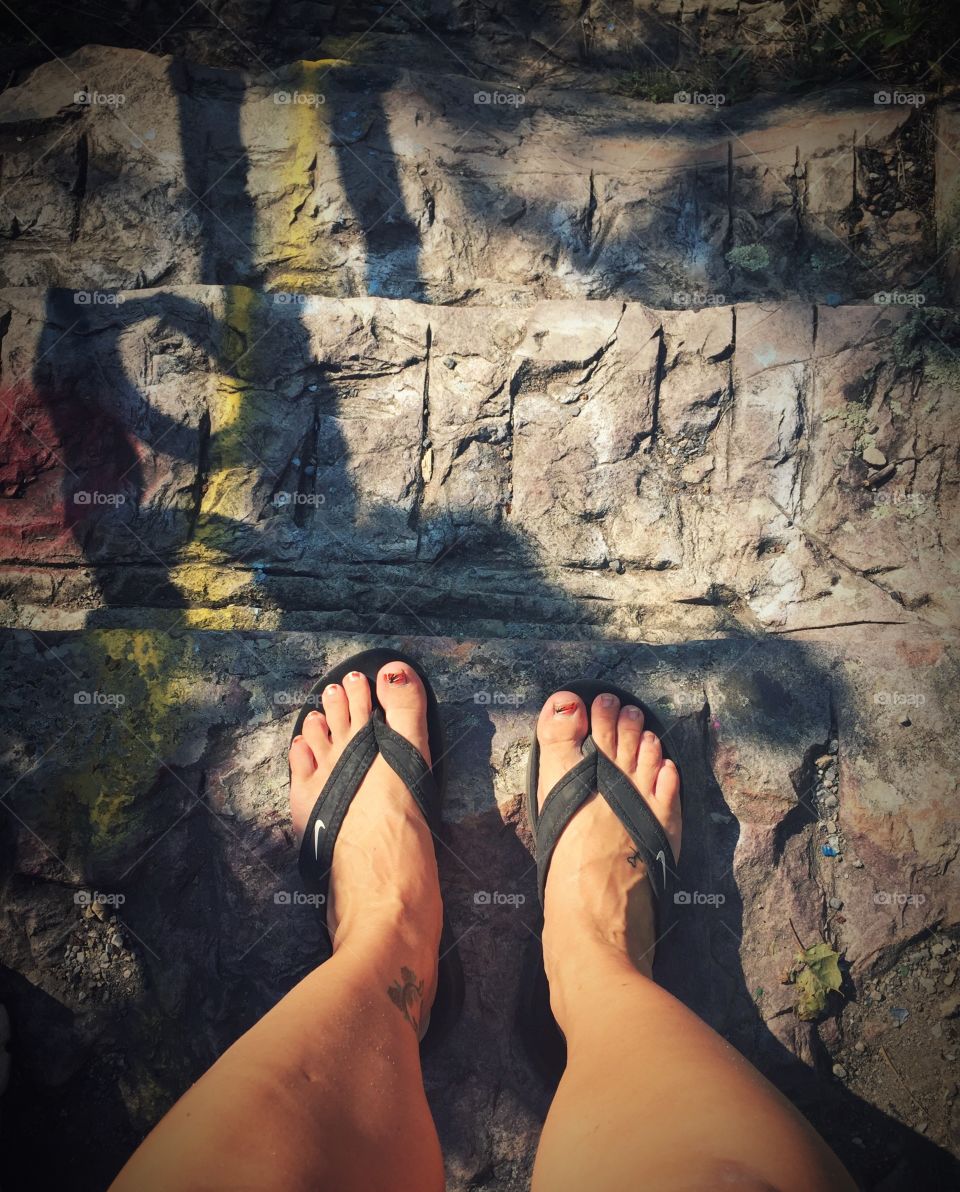 Walking down a stone staircase after visiting the scenic cliffs. 
