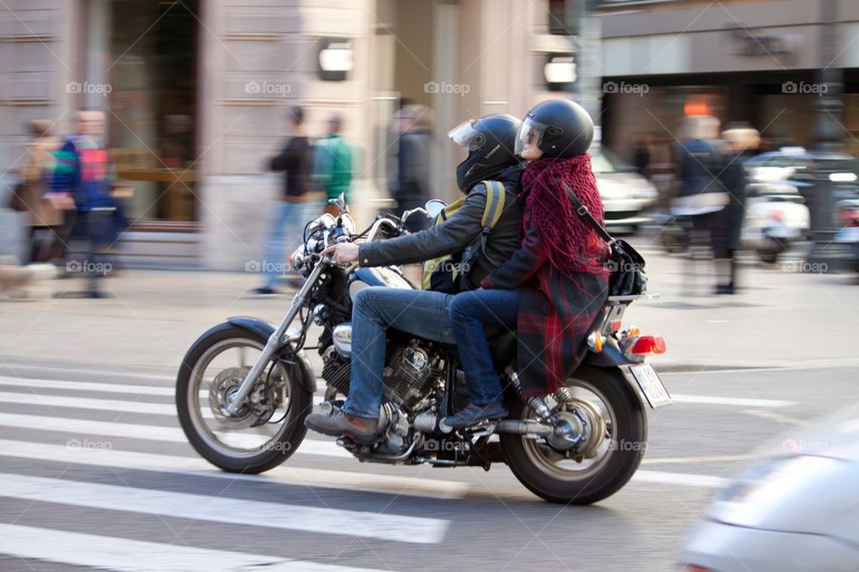 Couple on motorcycle in the city.