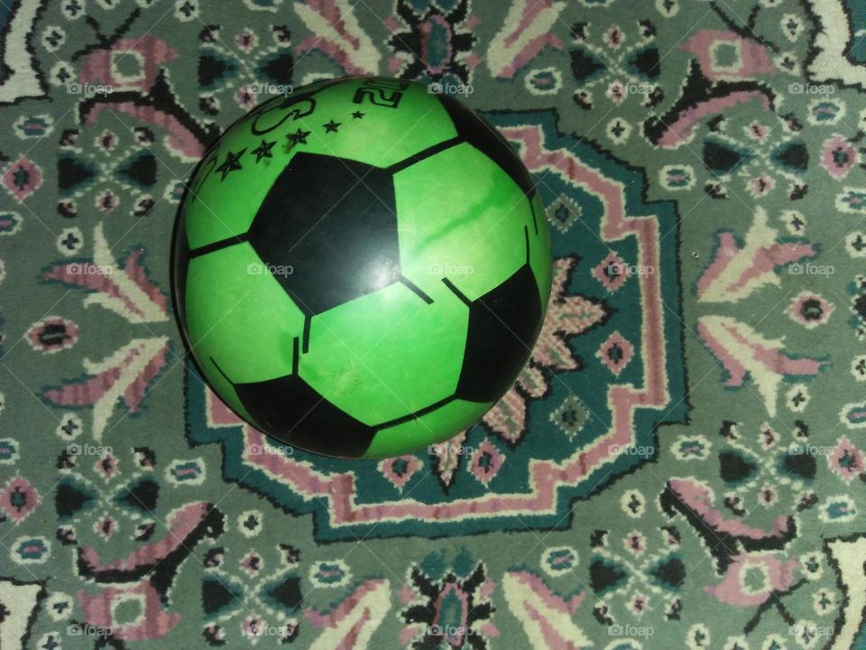 Green ballons on the carpet.