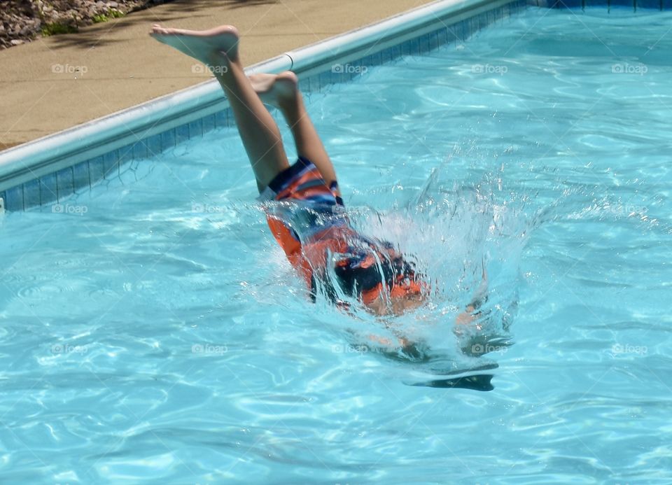 A boy diving into the swimming pool 
