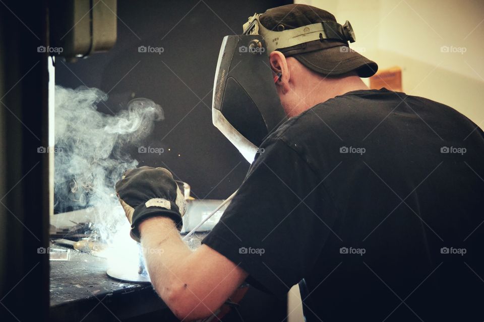 Welder man working in workshop