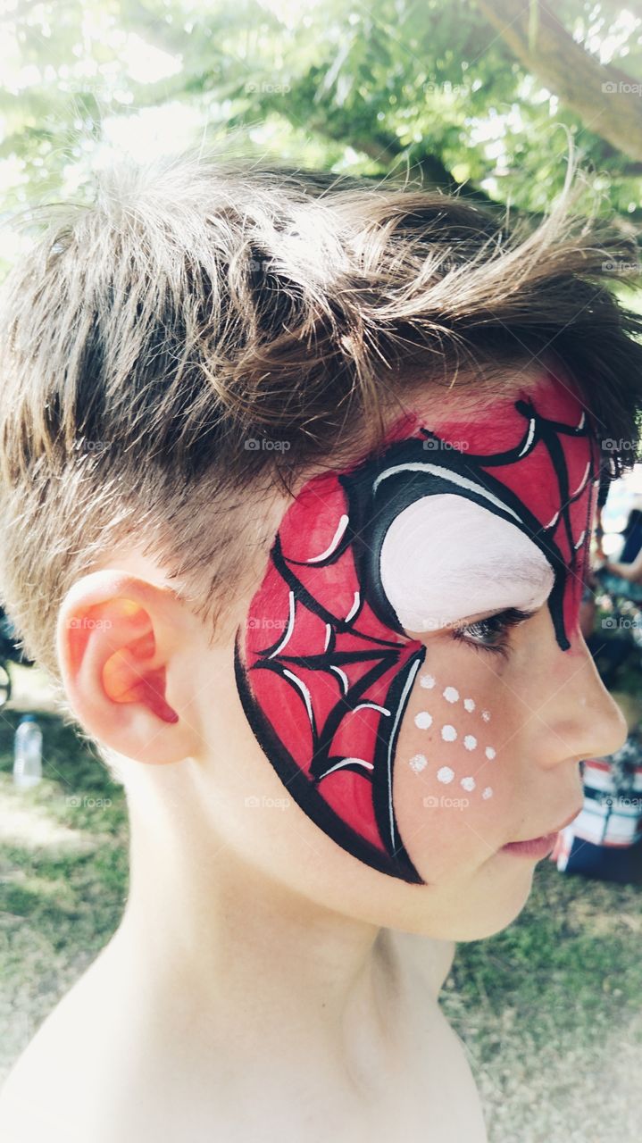 Face painted at a summer festival.