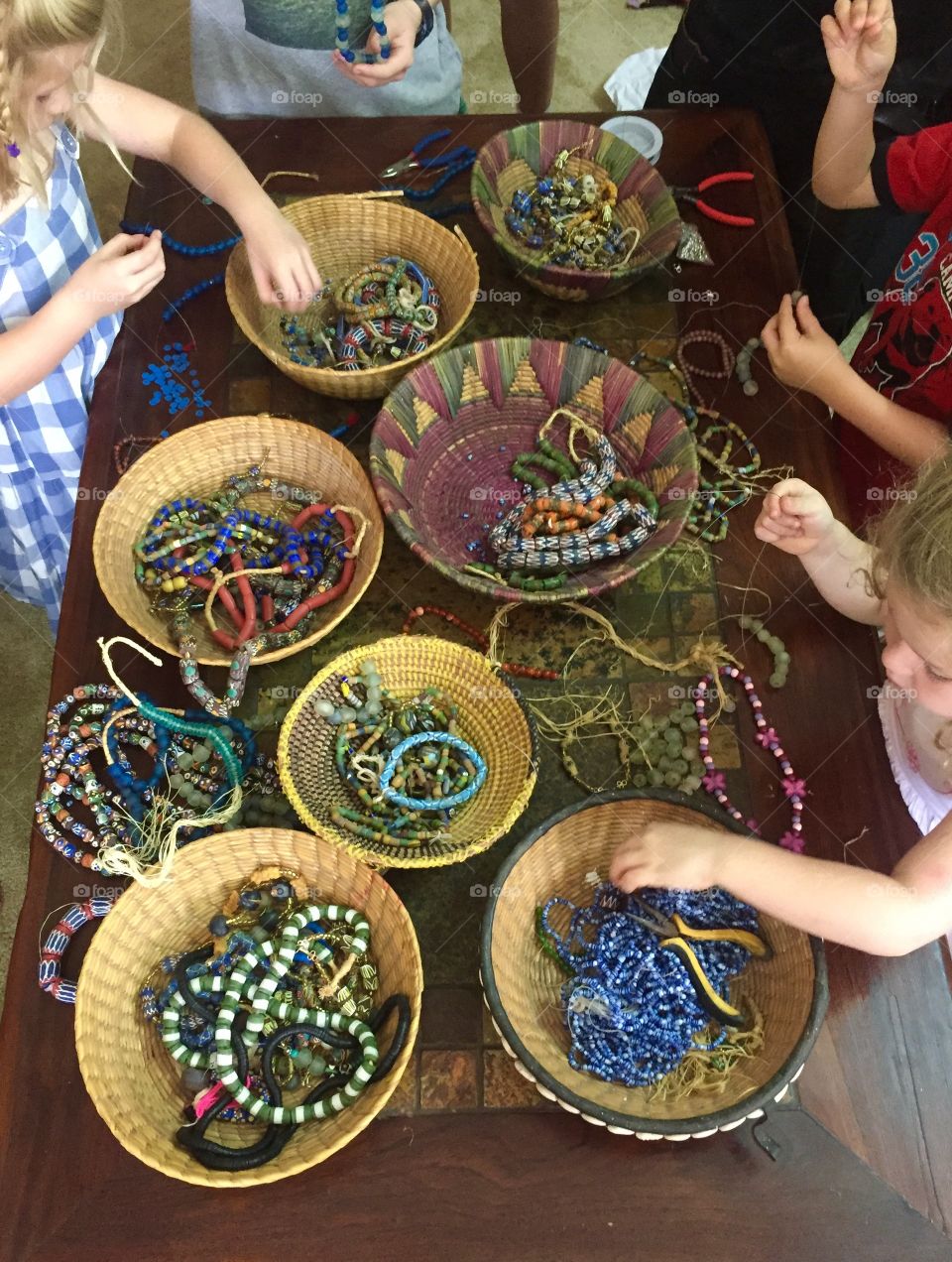 Children making jewellery with beads